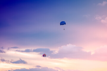 Parasailing on sunset and blue sky background in tropical country