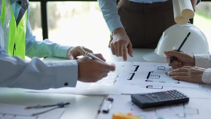 Architect or engineer are designing house, modifying plan, creating construction project and addition according to customer requirement.