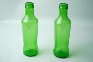 Glass bottles of soda on white background
