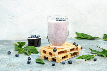 blueberry yoghurt shake in glass jar on a light background, place for text, top view