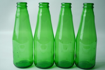 Glass bottles of soda on white background