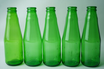 Glass bottles of soda on white background