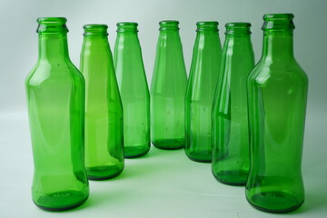 Glass bottles of soda on white background