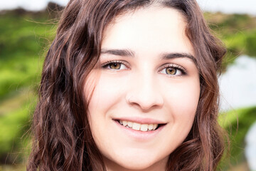 portrait of young brunette woman outdoors