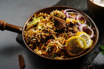Hyderabadi Mutton goat biryani served with yogurt raita on moody setting