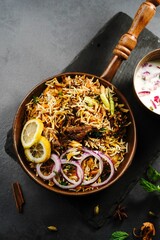 Hyderabadi Mutton goat biryani served with yogurt raita on moody setting