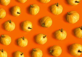 Pumpkin pattern. Flat lay, top view. Halloween, thanksgiving day, autumn theme. Abstract background. Minimalistic fall vegetables concept