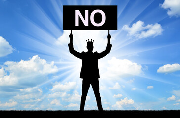 Selfishness. Selfish male businessman or boss with a crown, holding a poster with the word no.