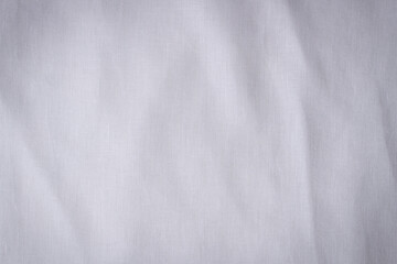 Fototapeta na wymiar White crumpled linen fabric texture background. Natural linen organic eco textiles canvas background. Top view