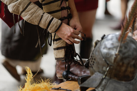 Roman gladiator getting equiped during a historic reenactment event.