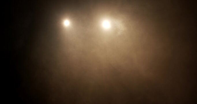 camera moves in two spots with fog on a stage