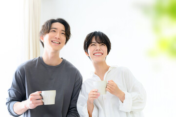 コーヒーを持って見上げるカップル