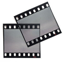 two single 35mm filmstrips overlapping each other on white paper background.