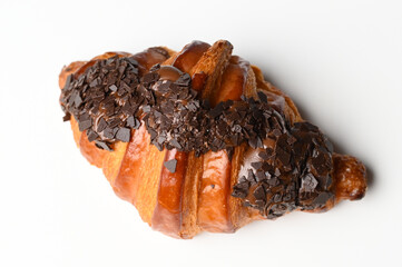 Croissant with chocolate chip topping isolated on white background. Top view