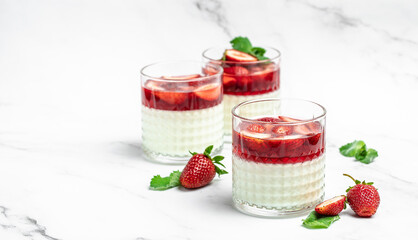 Italian panna cotta dessert with strawberry and mint on a light background. Summer yogurt dessert. space for text