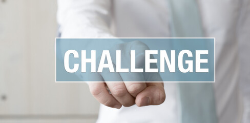 businessman pointing his finger at a blue sign with the message challenge- Job concept