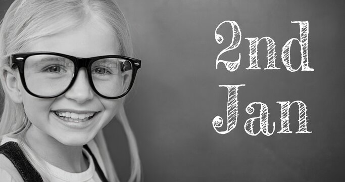 Composite of 2nd jan text with portrait of smiling cute caucasian girl wearing eyeglasses
