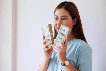 Asian woman hand holding money saving money financial planning.