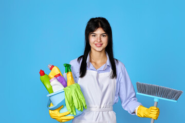 woman in gloves holding bucket of detergents and broom