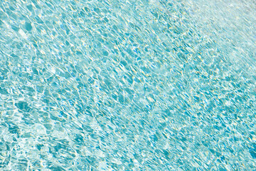blue color background of swimming pool underwater with ripples in summer