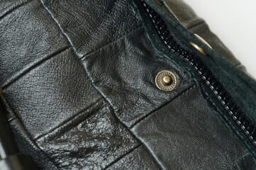 Metal knob and zipper on leather bag