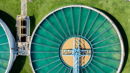 Aerial top view wastewate water treatment plant, Purification tanks of wastewater treatment plant, Top view sewage treatment plant, aerial view solid contact clarifier tank. © Darunrat