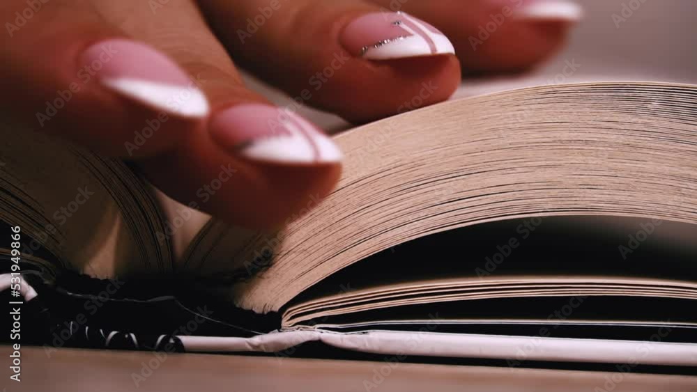 Poster turning pages in a white book close up slow mo. reading a book, intelligence. pages flow one after a