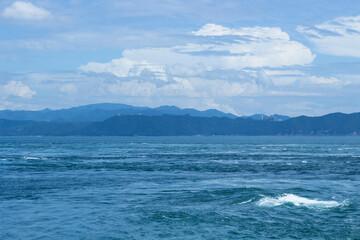 Fototapeta na wymiar 渦潮のある空と海の風景　whirlpool landscape