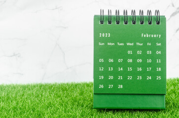 The Green February 2023 Monthly desk calendar for 2023 year on grass.