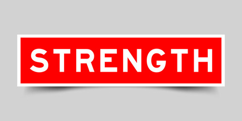 Red color square shape sticker label with word strength on gray background