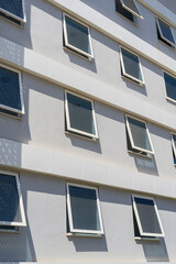 A number of identical windows. Part of the building.