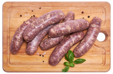 Raw beef or pork grill sausage on wooden cutting board isolated