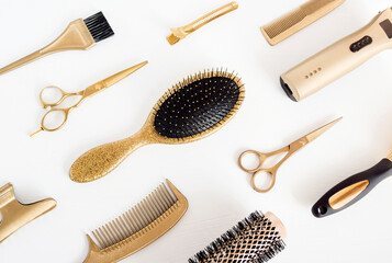 Background with golden hairdresser tools. Hair salon accessories, comb, scissors on white