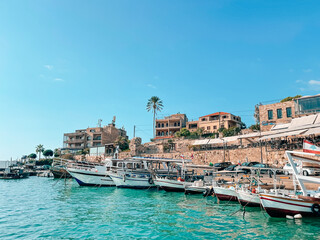 View of Famous and Historic Mediterranean Coastal Town: Byblos, Lebanon - Tourist attractions of Byblos with restaurants and boats in Lebanon - view from the ocean