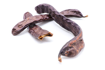 closeup of carob isolated on a white background
