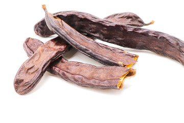 closeup of carob isolated on a white background