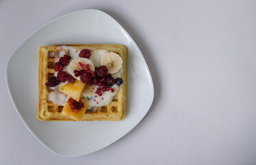 waffles with cream, fruits and sprinkles