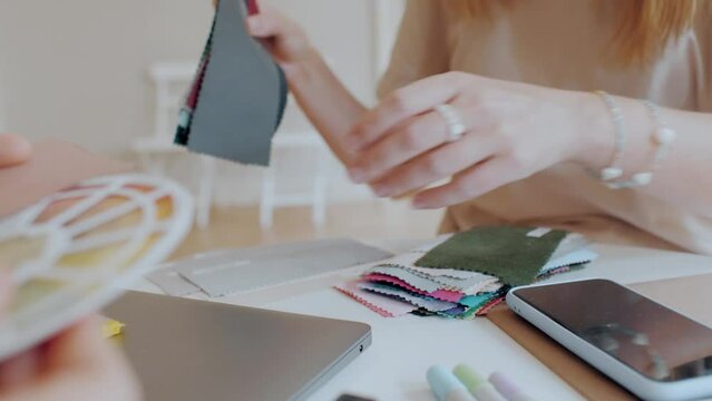Female designer hands choosing textile samples event decor closeup woman decorators brainstorming