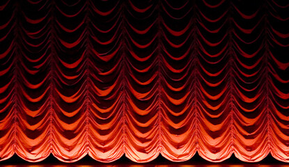red curtains illuminated by spotlight in theaters or cinema