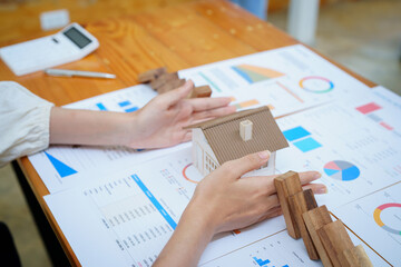 bank employee gesturing to protect the house from insurance