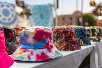 colorful hats in a street stall during a popular festival in Italy