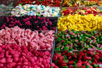 Assorted colorful gummy candies on a street stall during a folk festival in Italy