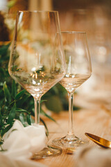 wedding decor ceremony dining tables with flowers tableware plates forks spoons knives napkins vases candles glasses festive dinner restaurant inside christmas light bulbs light romance