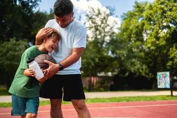 Obraz premium Father and son connect through sports activities, play basketball and enjoy a sunny day