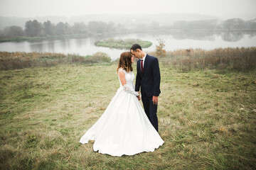 Romantic wedding moment, couple of newlyweds smiling portrait, bride and groom hugging