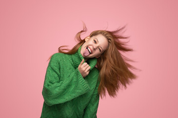 Ginger woman showing tongue and shaking hair