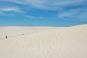Rippled sand background, dune and see in Slowinski National Park, Leba, Poland. Beautiful scenery of sand dunes and ocean.