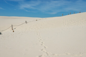 Rippled sand background, dune and see in Slowinski National Park, Leba, Poland. Beautiful scenery of sand dunes and ocean.