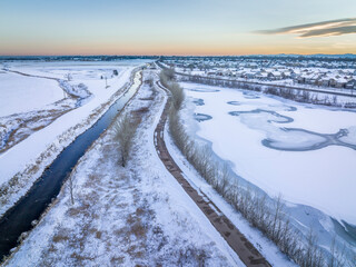 irrigation channel, bike trail and frozen pond, winter scenery after sunset, aerial view of Fort Collins area in northern Colorado