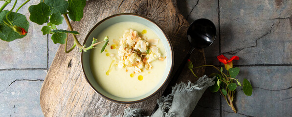 bowl of creamy cauliflower soup on the table - obrazy, fototapety, plakaty